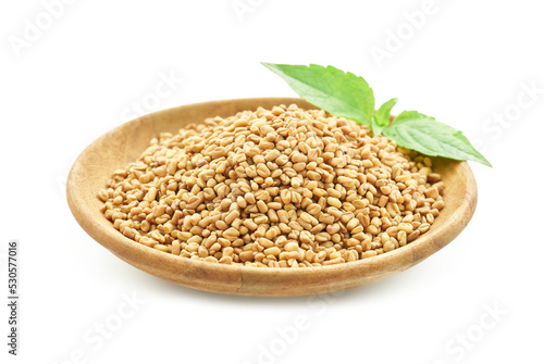 fenugreek seed in wood plate and green leaves isolated on white background. fenugreek isolated 