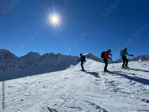 Group of people ski touring in the Austrian Alps. Bregenzerwald, Vorarlberg, Austria.