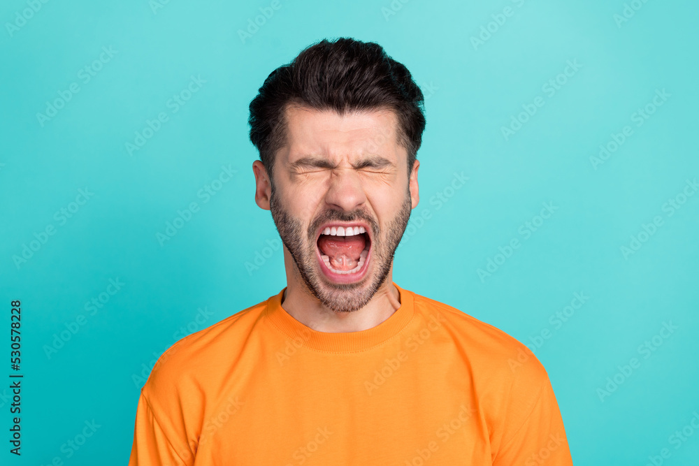 Closeup photo of young attractive handsome bearded man open mouth screaming unhappy depressed deadline isolated on aquamarine color background Closeup photo of young attractive handsome bearded man open mouth screaming unhappy depressed deadline isolated on aquamarine color background