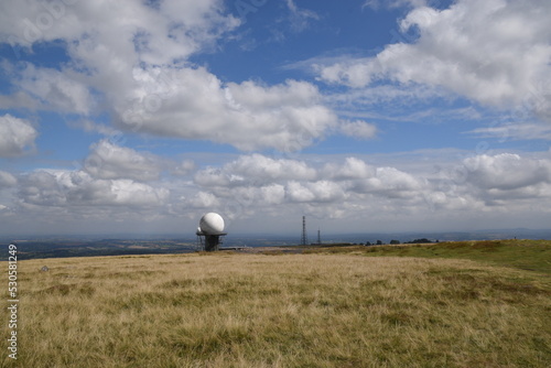 a view of the radar station at Titterstone Clee summit with the sky clear blue with fluffy clouds