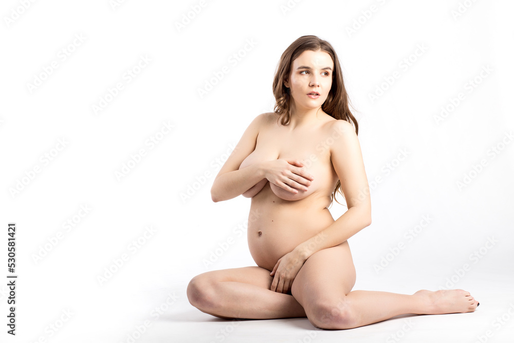 young attractive naked pregnant woman, isolated on white background young attractive naked pregnant woman, isolated on white background