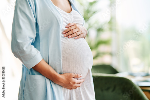 Closeup of pregnant woman holding her belly. Motherhood care concept