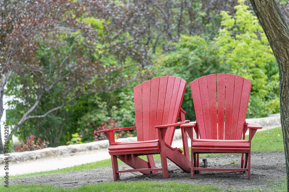 Two Red chairs in a public park Two Red chairs in a public park