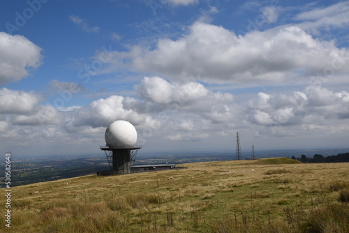 a view of the radar station at Titterstone Clee summit with the sky clear blue with fluffy clouds