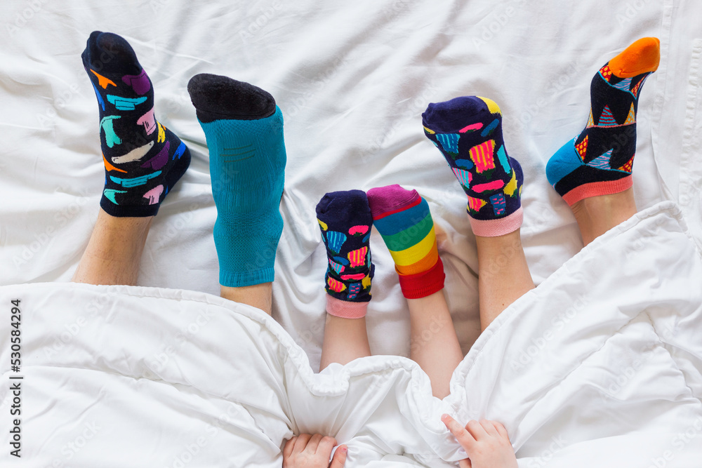 Colorful socks on feet as a symbol of World Down Syndrome Day.