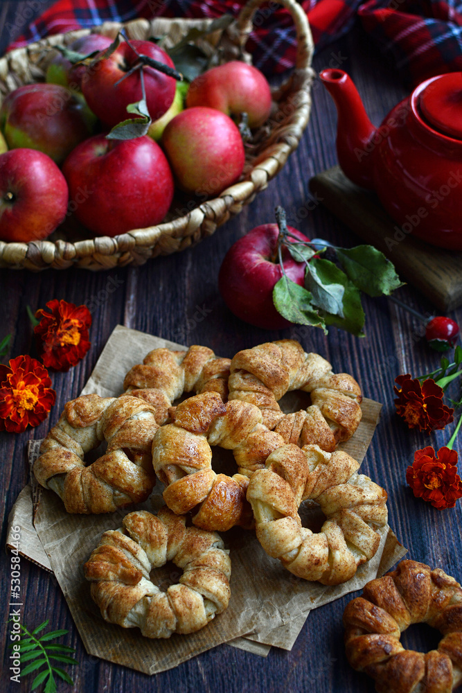 Homemade cake with apples and red apples in a basket on a rustic background. season, harvest