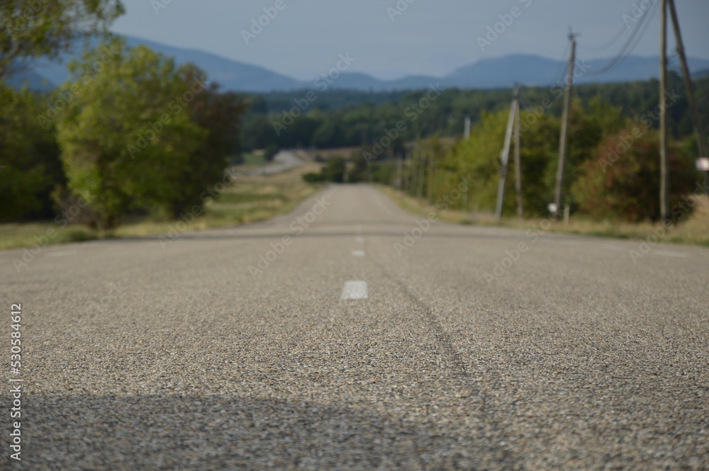 Obraz premium Long asphalt road in the countryside, France