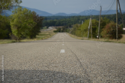Long asphalt road in the countryside, France