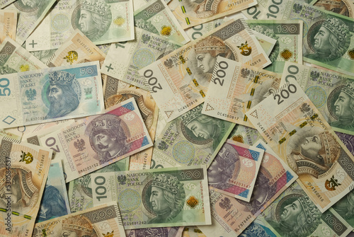 Paper money background. Polish zlotys lie in an even layer on the table. High quality photo