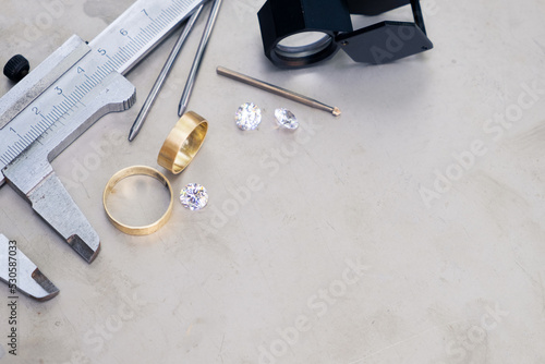 Wedding golden rings and professional jeweler equipments. Luxury diamonds photo