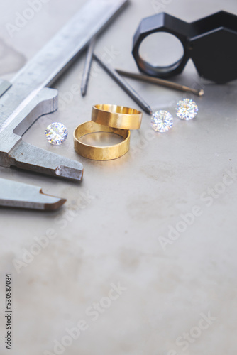 Wedding golden rings and professional jeweler equipments. Luxury diamonds