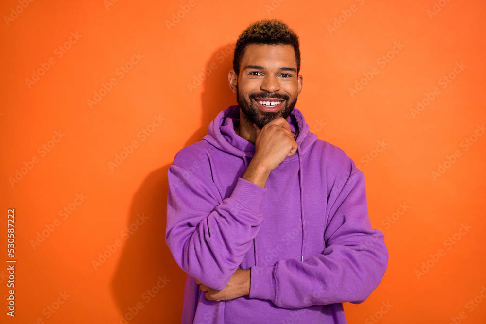 Photo of positive minded man hold arm hand hold chin imagine good shopping day isolated on orange color background