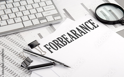 FORBEARANCE text on paper with chart and keyboard, business concept