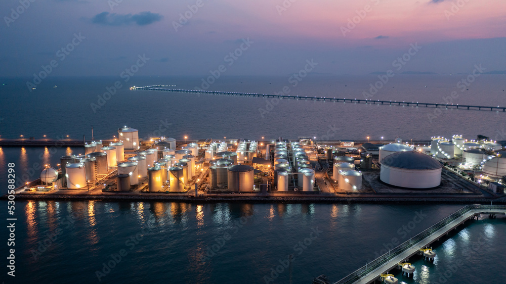 Aerial view chemical storage tank on sea at oil terminal station at night, Chemical plant petroleum and petorchemical product, Chemical industry plant in refinery at night,