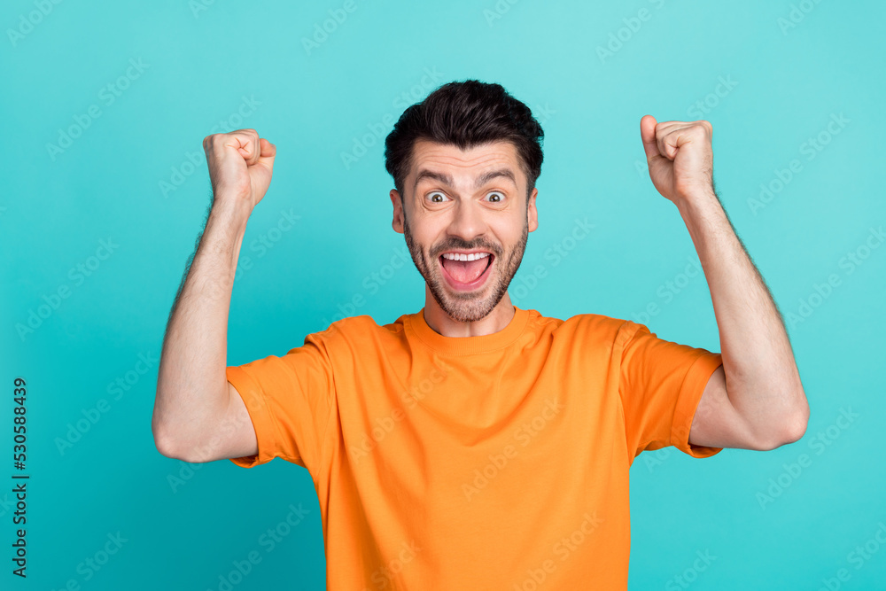 Closeup photo of young attractive handsome funny man excited fists up celebrate hooray winner tournament positive nice isolated on aquamarine color background Closeup photo of young attractive handsome funny man excited fists up celebrate hooray winner tournament positive nice isolated on aquamarine color background