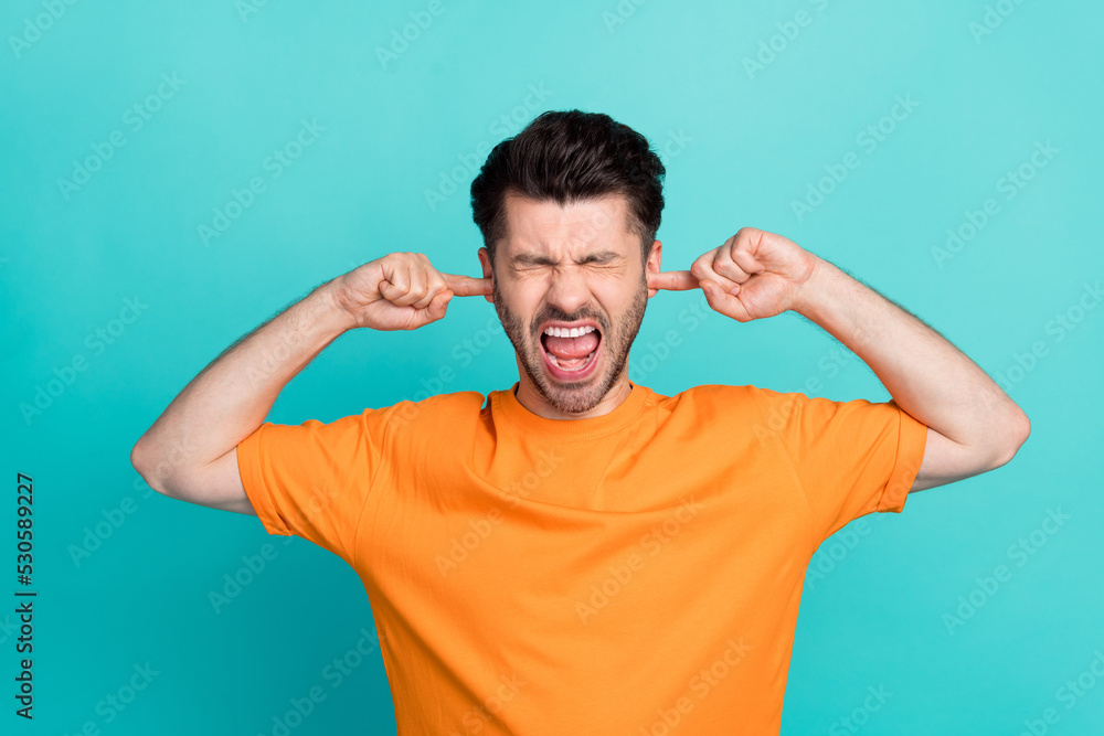 Portrait photo of young attractive handsome bearded unhappy angry agressive impressed put fingers ears scream isolated on aquamarine color background Portrait photo of young attractive handsome bearded unhappy angry agressive impressed put fingers ears scream isolated on aquamarine color background