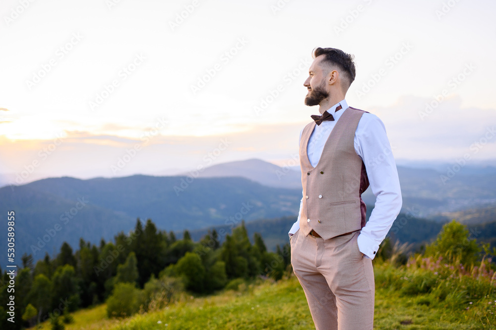 Stylish fiance posing on top enjoying view on mountains Stylish fiance posing on top enjoying view on mountains