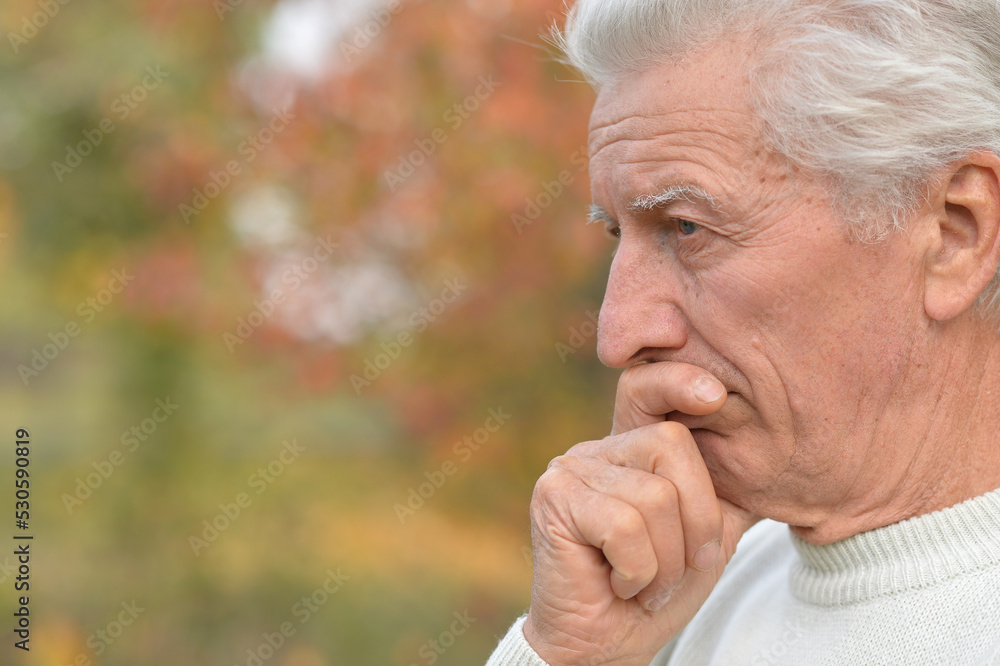 Close up portrait of older man in autumn park Close up portrait of older man in autumn park