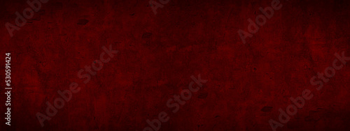 Abstract old aged damaged cracked grunge dark red colored concrete cement plaster facade wall texture colorful background banner panorama wide pattern