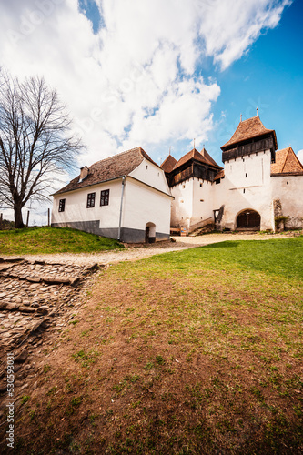 Viscri, Romania: Blue old painted traditional house from village, Transylvania, German Saxon community. Unesco. The Viscri fortified church photo