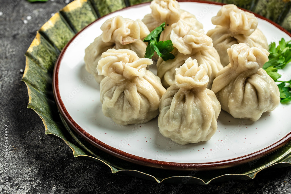 Georgian dumplings Khinkali with meat and spicy sauce. banner, menu, recipe place for text, top view Georgian dumplings Khinkali with meat and spicy sauce. banner, menu, recipe place for text, top view
