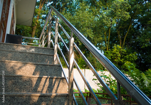 A closeup shot of granite stone staircase with steel railings in a modern household construction. Dehradun City India