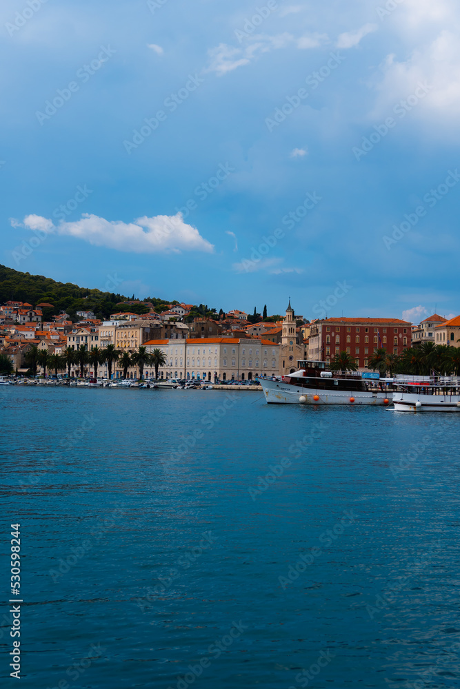 beautiful town a promenade with palm treesm, a church and boats in Split, Croatia