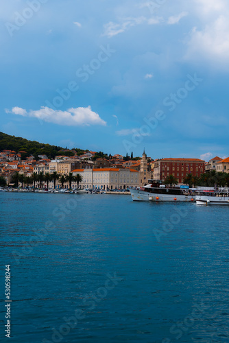 beautiful town a promenade with palm treesm, a church and boats in Split, Croatia