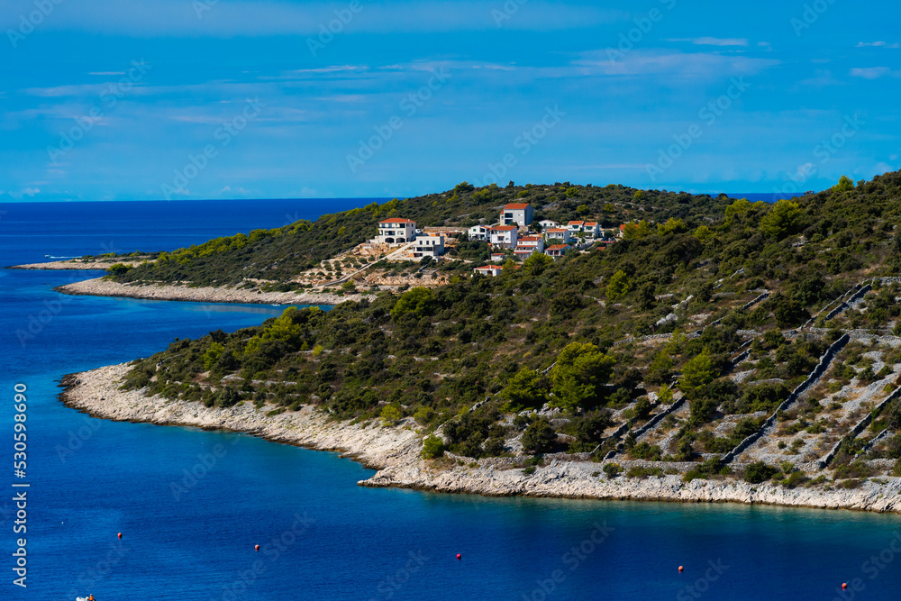 Naklejka premium view of the coastline with a small village in the background in Sevid, Croatia