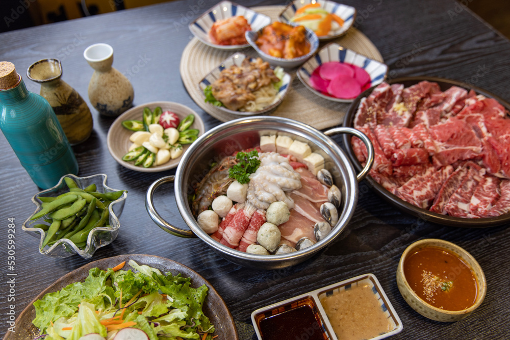 Korean traditional style assorted bbq grilled set, fresh Asian side dish vegetables, and shabu-shabu