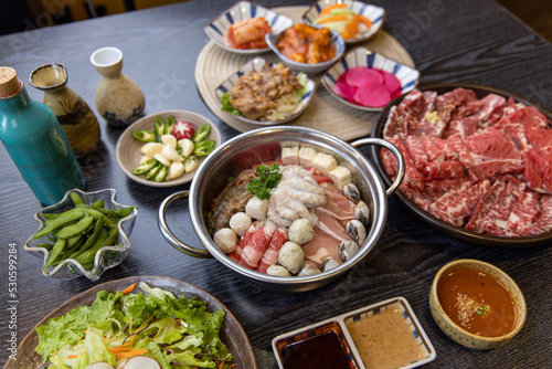 Korean traditional style assorted bbq grilled set, fresh Asian side dish vegetables, and shabu-shabu © Kim