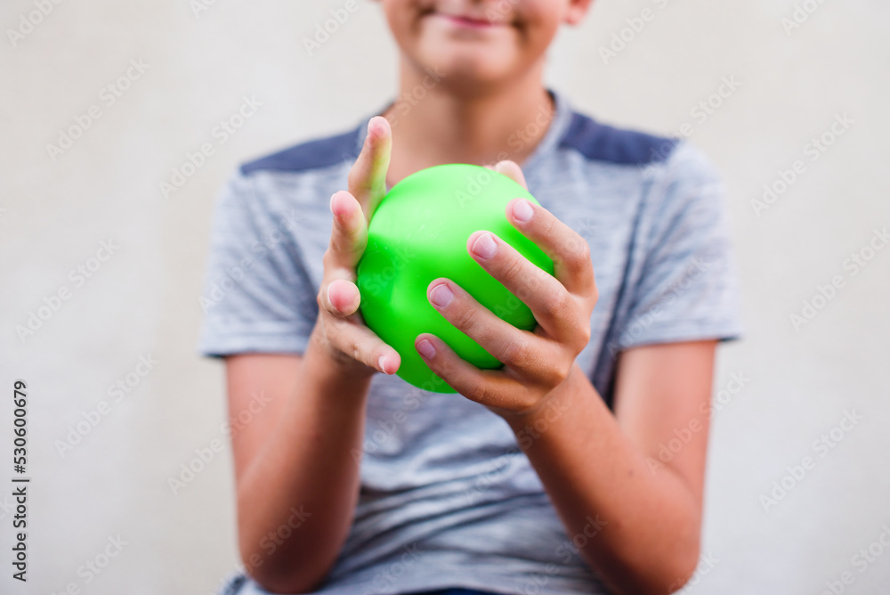 Teen boy playing with anti stress sensory ball squeeze toy. Giant stress balls are soft to the touch and help reduce stress and anxiety as you pull, squish, smash, squash, and grip them in all kinds Teen boy playing with anti stress sensory ball squeeze toy. Giant stress balls are soft to the touch and help reduce stress and anxiety as you pull, squish, smash, squash, and grip them in all kinds