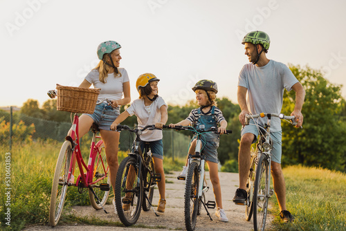 Happy family cycling together in the countryside
 photo