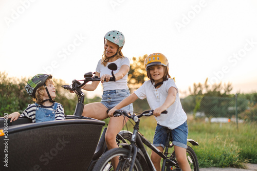 Mother with children cycling in the countryside
 photo