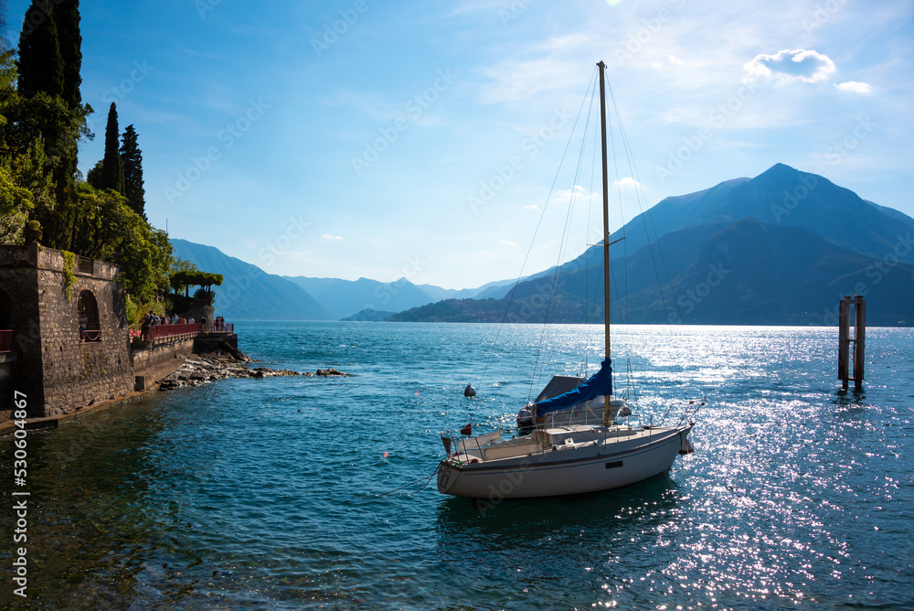 Beautiful panorama of lake Como in summer, boat next to coast