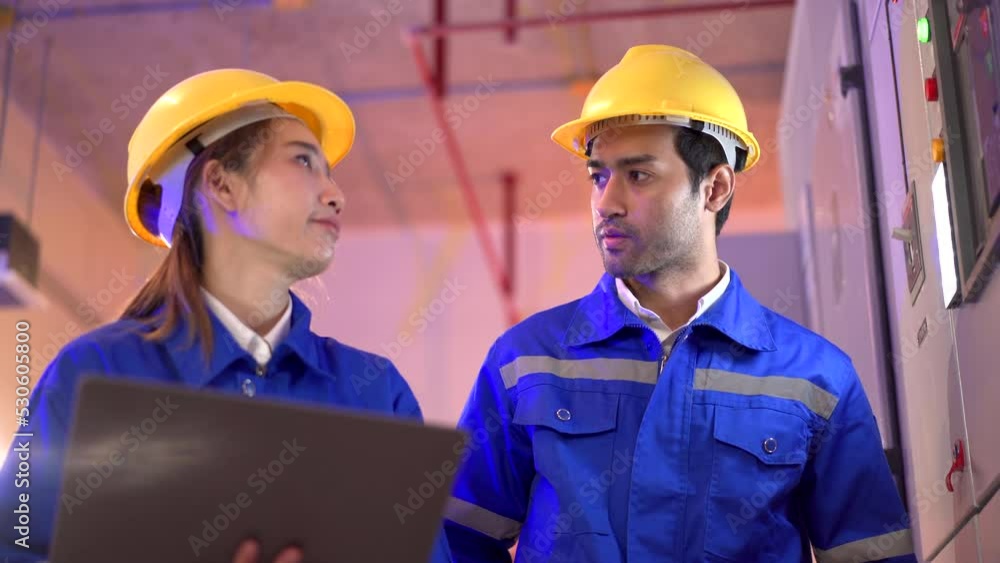 Electrical engineers making a discussion together. Engineer team working in electric control room. Electrical engineers making a discussion together. Engineer team working in electric control room.