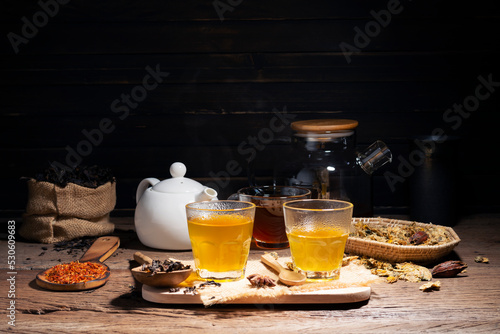 Brew hot tea, chrysanthemum tea, and chrysanthemum flowers. Safflower arranged on a wooden table Healthy drinks to drink herbs and medical concepts