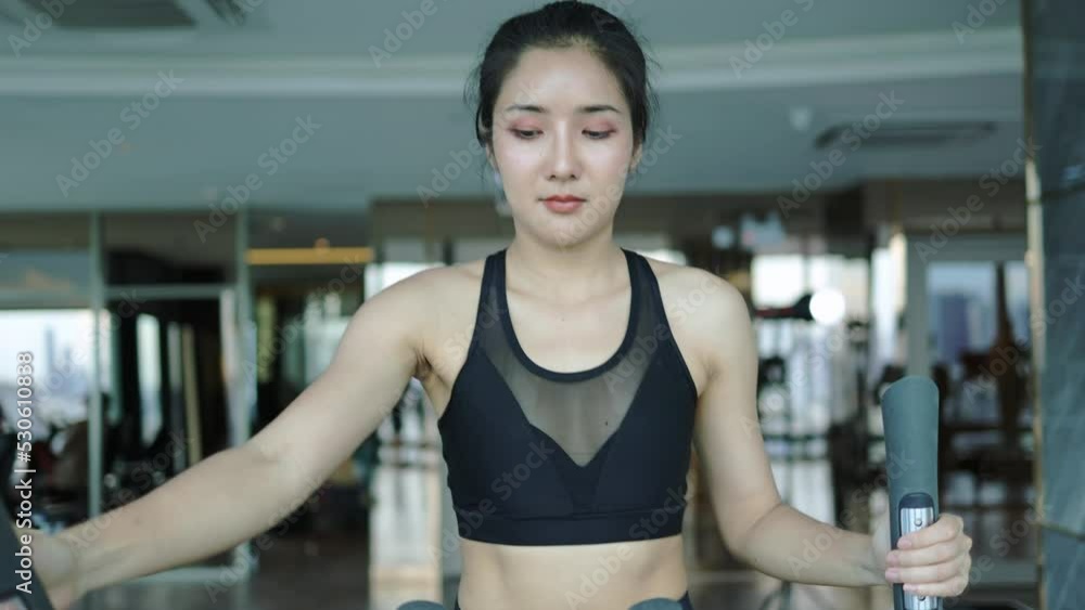woman exercising elliptical machine slow motion in gym woman exercising elliptical machine slow motion in gym