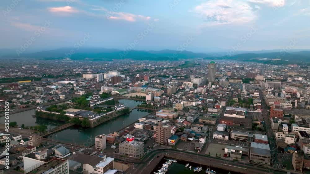 Aerial view of Imabari Castle Park and city center in early morning blue hour Aerial view of Imabari Castle Park and city center in early morning blue hour