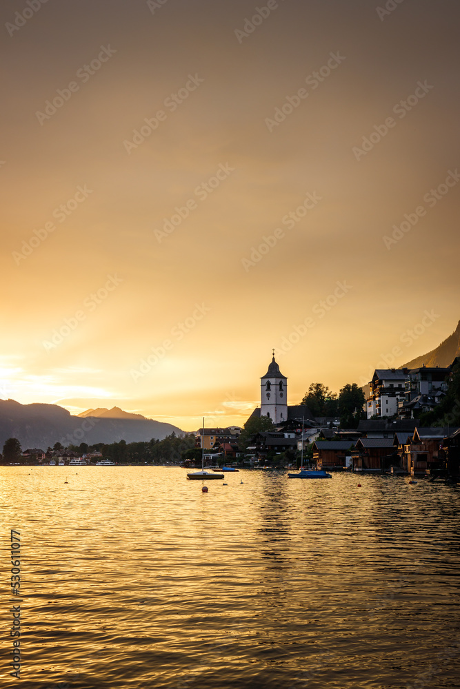 Sunset over Wolfgangsee lake at St. Wolfgang, Upper Austria. Golden hour during twilight. European Alps mountains travel destination