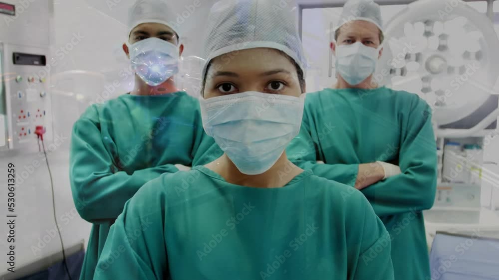 Animation of diverse doctors in masks at operating room over welder welding equipment in workshop Animation of diverse doctors in masks at operating room over welder welding equipment in workshop