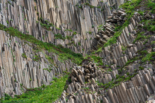 landscape with columnar basalt rocks forming a natural geometric pattern photo
