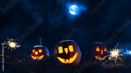 Halloween pumpkins in a misty night scene with smoke.  © Miha Creative