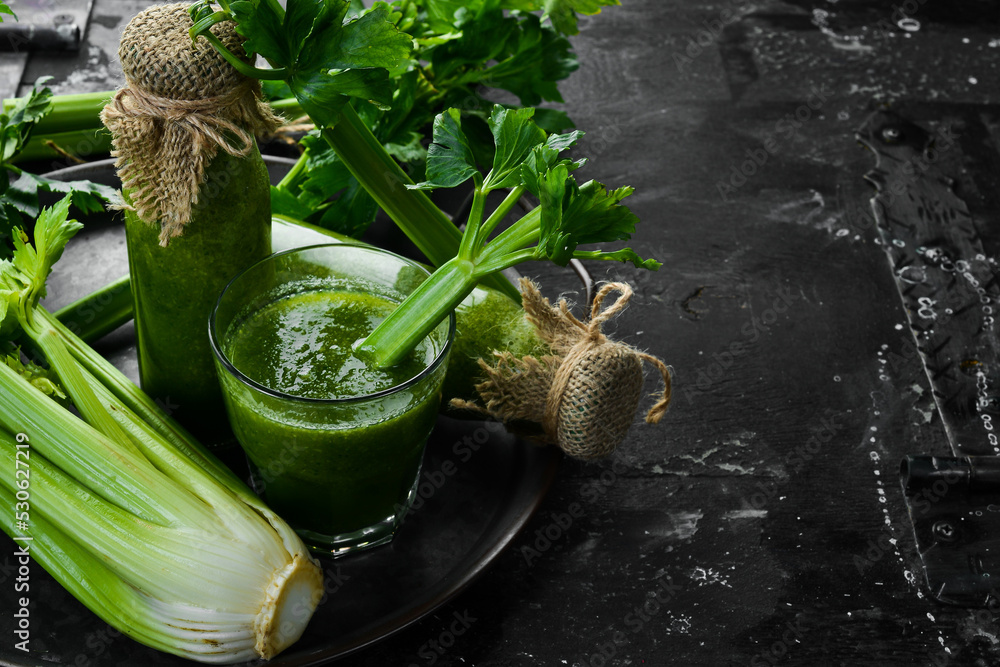 Celery smoothie and fresh celery on a stone background. Healthy food. Free space for text. Celery smoothie and fresh celery on a stone background. Healthy food. Free space for text.