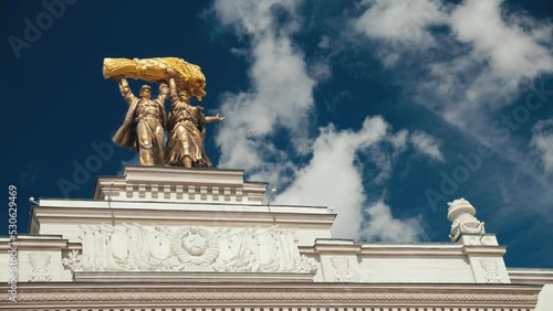 Golden workers statue, Soviet Union era monument, arch of main entrance, complex VDNKh, All-Russian Center VDNH, exhibition of achievements of USSR economy, recreational city park in Moscow, Russia.