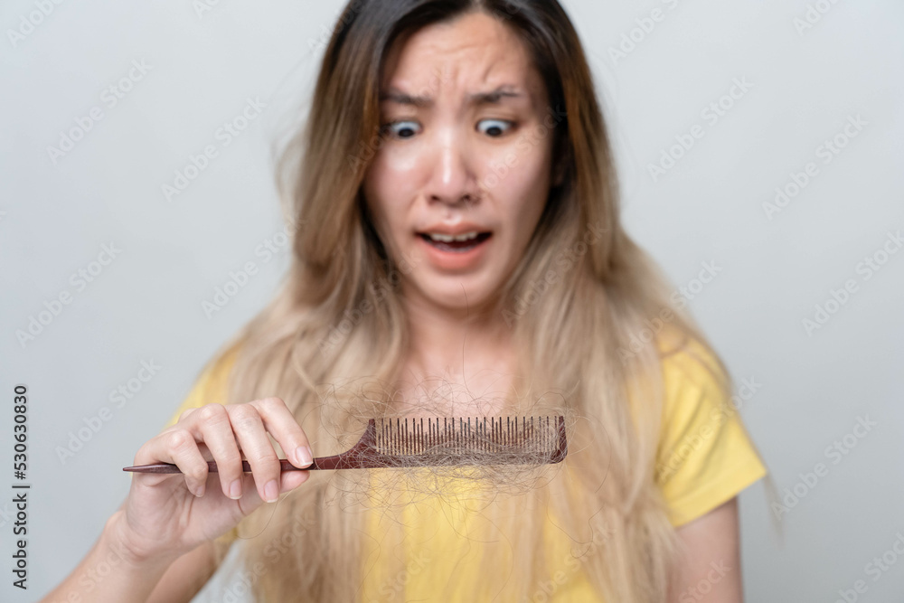 Concept of women's hair loss problem. Pictures of Asian women are shocked to see the amount of