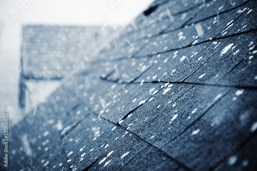 it is snowing above the shingle roof