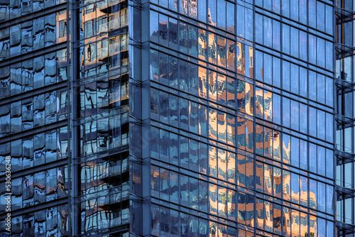 Skyscraper reflected on a glass facade