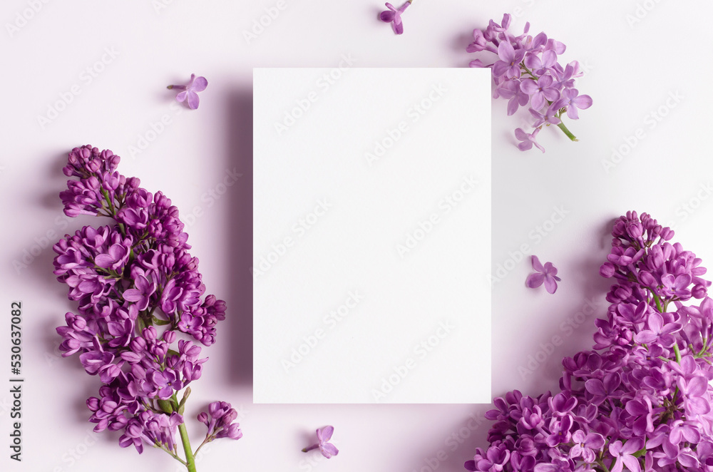Wedding invitation card mockup with spring lilac flowers on white