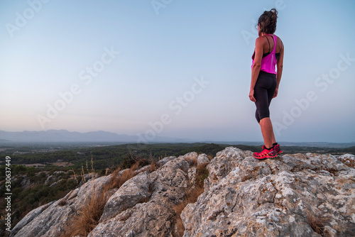 middle-aged woman walking across the ridge, Puig de Ses Bruixes, Llucmajor, Majorca, Balearic Islands, Spain
